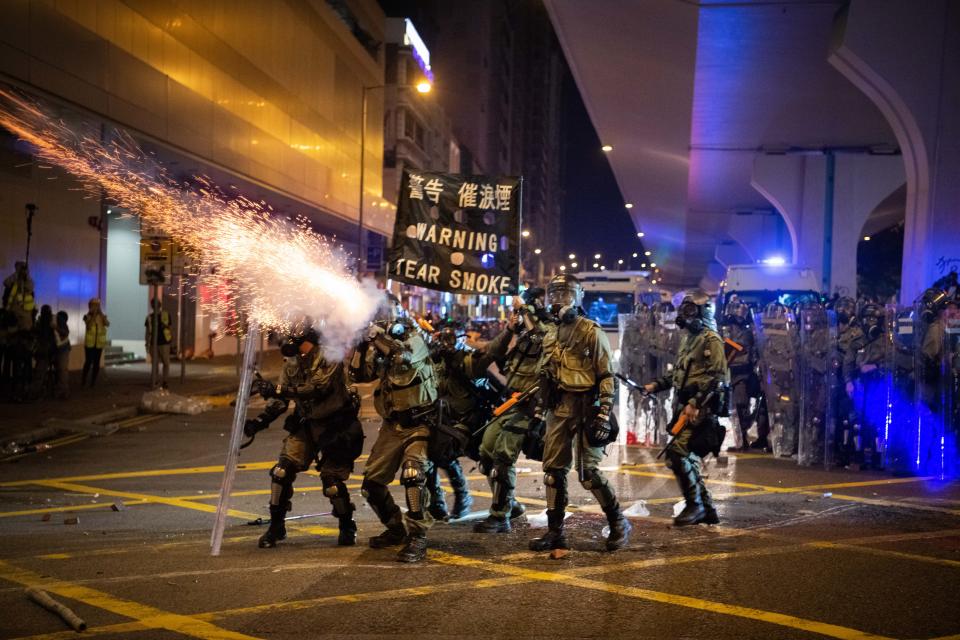 HONG KONG, CHINA - JULY 28: Riot police fire tear gas during a demonstration in the area of Sheung Wan on July 28, 2019 in Hong Kong, China. Pro-democracy protesters have continued weekly rallies on the streets of Hong Kong against a controversial extradition bill since 9 June as the city plunged into crisis after waves of demonstrations and several violent clashes. Hong Kong's Chief Executive Carrie Lam apologized for introducing the bill and recently declared it "dead", however protesters have continued to draw large crowds with demands for Lam's resignation and completely withdraw the bill. (Photo by Laurel Chor/Getty Images)