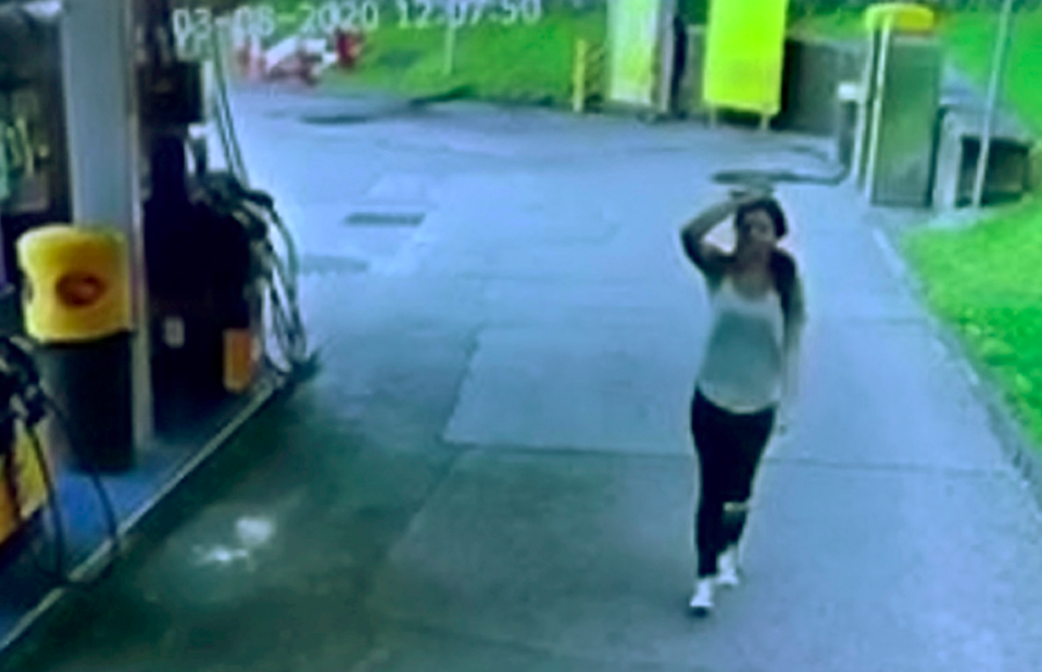 The woman was seen looking on helplessly as her car was stolen (SWNS)