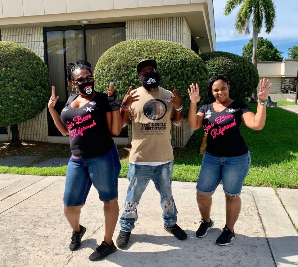 From left, Tabatha Bailey, Ijamyn Gray and Deshaun Jones pose for a photo after voting in Miami Tuesday, August 11, 2020. Each threw up “fours” in honor of Amendment 4, a measure that restored the right to vote for them and other former felons.