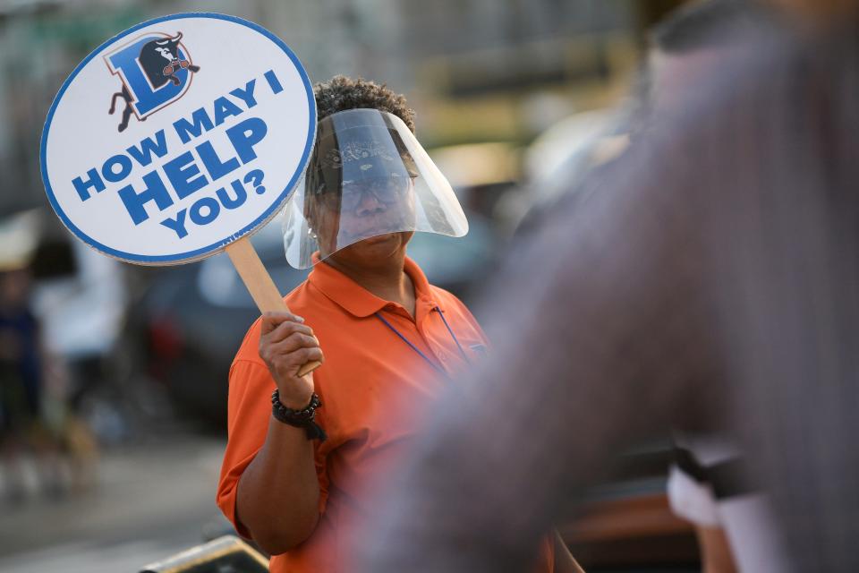 Fan ambassadors are stationed around Durham Bulls Athletic Park to help guide fans from parking areas into the stadium on game days. The Durham Bulls tries to ensure these workers reflect the community, so all types of people feel welcome at the stadium.