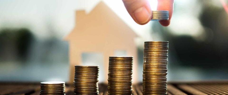 Saving to buy a house that hand putting money coins stack growing ,saving money or money growth concept