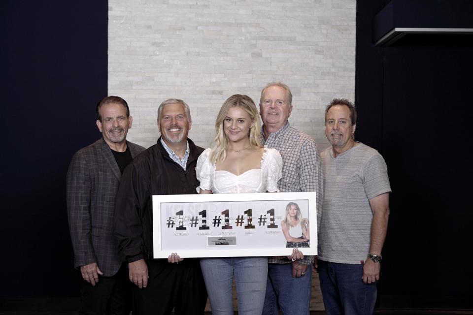 Rick Froio, Gordon Kerr, Kelsea Ballerini, Mike Wilson and Bill Macky pose with Ballerini's plaque celebrating her five No. 1 songs in four years.