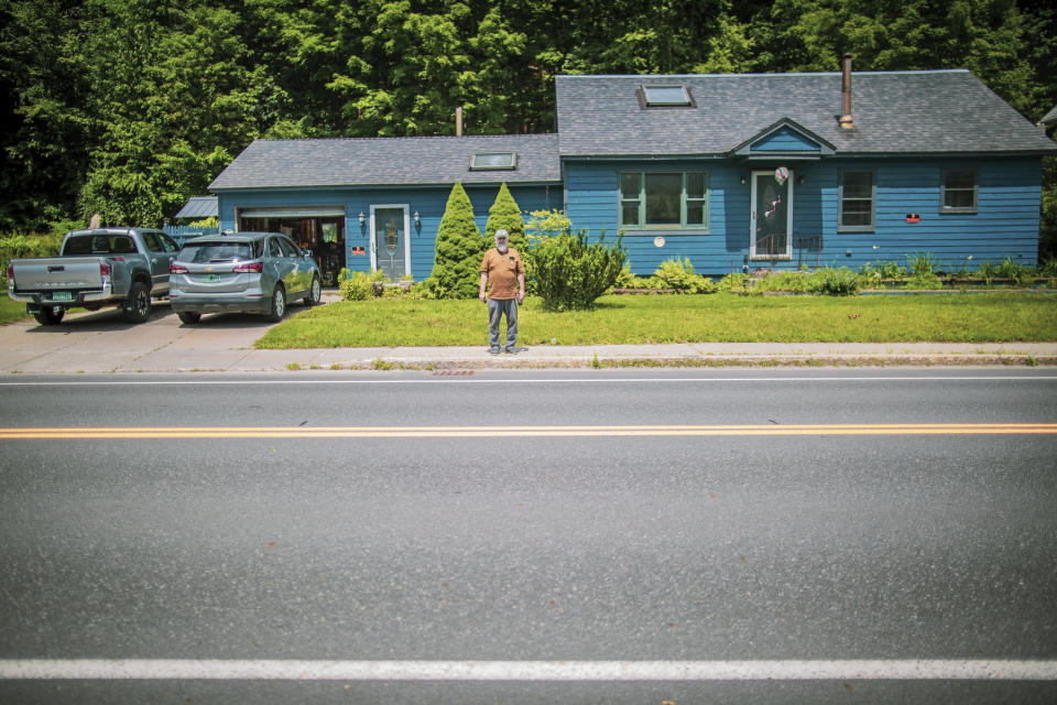 Ed Haggett, 70 poses for a portrait at his house in Montpelier, Vt., July 3, 2024, that was damaged by the 2023 flood. Haggett is waiting to hear whether the city or the Federal Emergency Management Agency will buy his home. A year after catastrophic flooding inundated parts of Vermont, some homeowners are still in the throes of recovery.