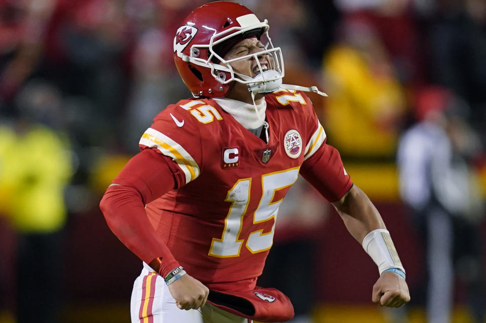 Kansas City Chiefs quarterback Patrick Mahomes (15) celebrates after throwing a touchdown pass during the first half of an NFL divisional round playoff football game against the Buffalo Bills, Sunday, Jan. 23, 2022, in Kansas City, Mo. (AP Photo/Ed Zurga)