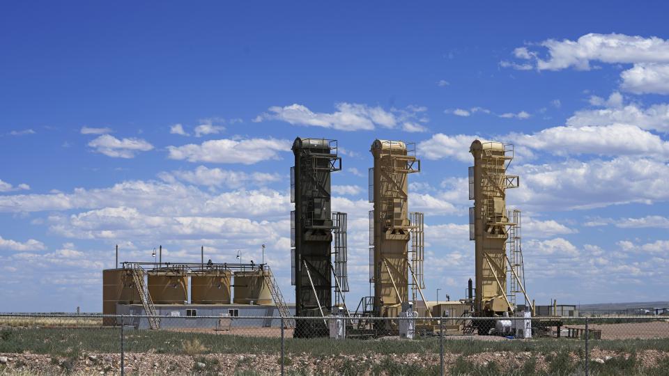 Well pads used for horizontal drilling stand in the Uinta Basin near Duchesne, Utah on Thursday, July 13, 2023. Uinta Basin Railway, one of the United States' biggest rail investment in more than a century, could be an 88-mile line in Utah that would run through tribal lands and national forest to move oil and gas to the national rail network. Critics question investing billions in oil and gas infrastructure as the country seeks to use less of the fossil fuels that worsen climate change. (AP Photo/Rick Bowmer)