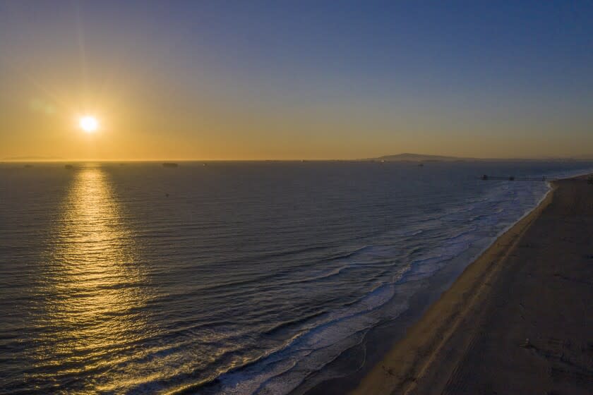 HUNTINGTON BEACH, CA - February 17: The sun sets over the ocean at Huntington state and city beaches Wednesday, Feb. 17, 2021 in Huntington Beach, CA. (Allen J. Schaben / Los Angeles Times)