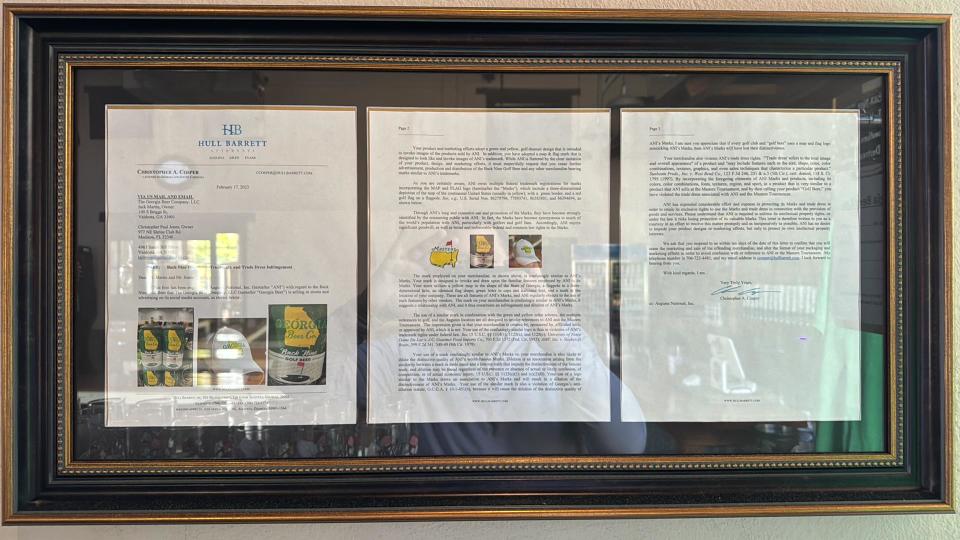 A framed copy of the cease and desist letter George Beer Company got from The Masters regarding their beer label design.