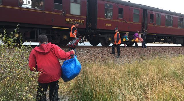 Children run towards a train near Loch Eilt in the Scottish Highlands. Source: Jon Cluett via AAP