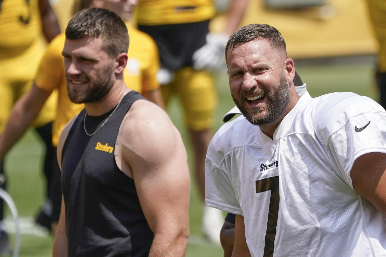 Pittsburgh Steelers outside linebacker T.J. Watt, left, and quarterback Ben Roethlisberger (7) react as they watch one-on-one blocking drills between linebackers and running backs at NFL football practice, Wednesday, July 28, 2021, in Pittsburgh. (AP Photo/Keith Srakocic)