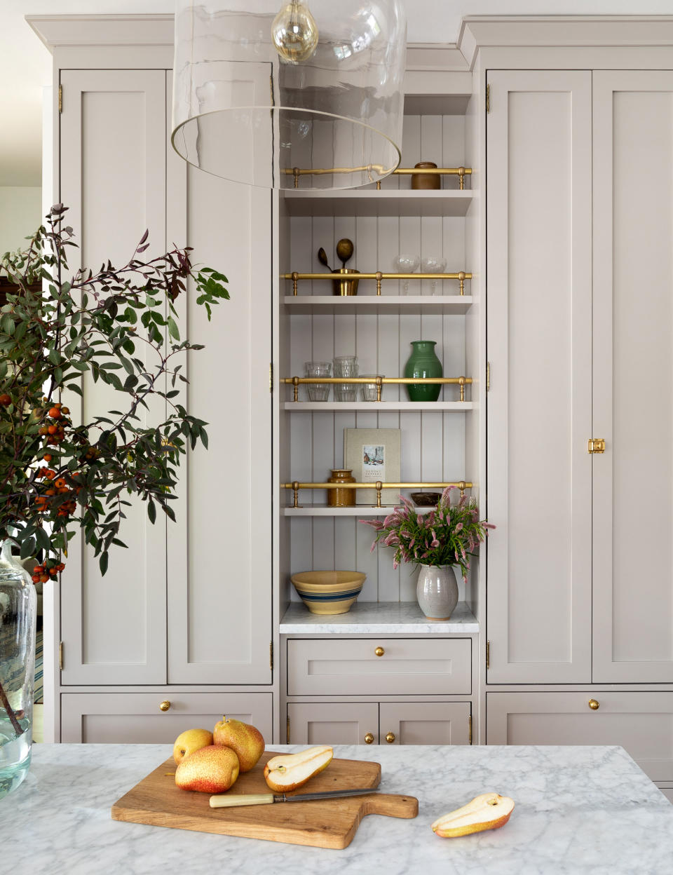 Beige pantry storage with gold handles