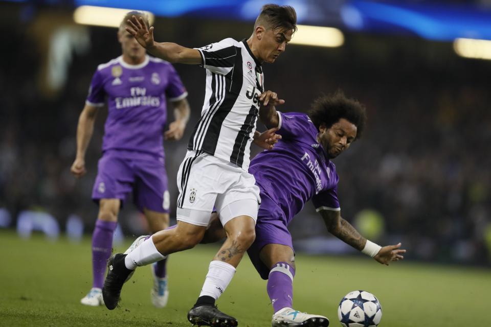 <p>Real Madrid’s Marcelo, right, challenges for the ball with Juventus’ Paulo Dybala during the Champions League final soccer match between Juventus and Real Madrid at the Millennium Stadium in Cardiff, Wales </p>
