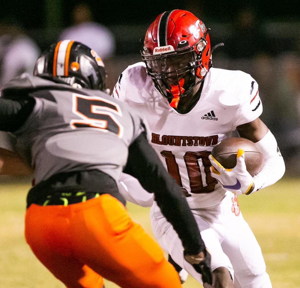 Blountstown Tigers Jordan Pride (10) drives upfield while meeting Hawthorne Hornets Jordin Fluellen (5) in the first half.  The Hawthorne Hornets hosted the Blountstown Tigers in the 2022 FHSAA Football State Championships playoff game at Hawthorne High School Stadium in Hawthorne, FL on Friday, December 2, 2022. Hawthorne won 28-0.  [Doug Engle/Ocala Star Banner]