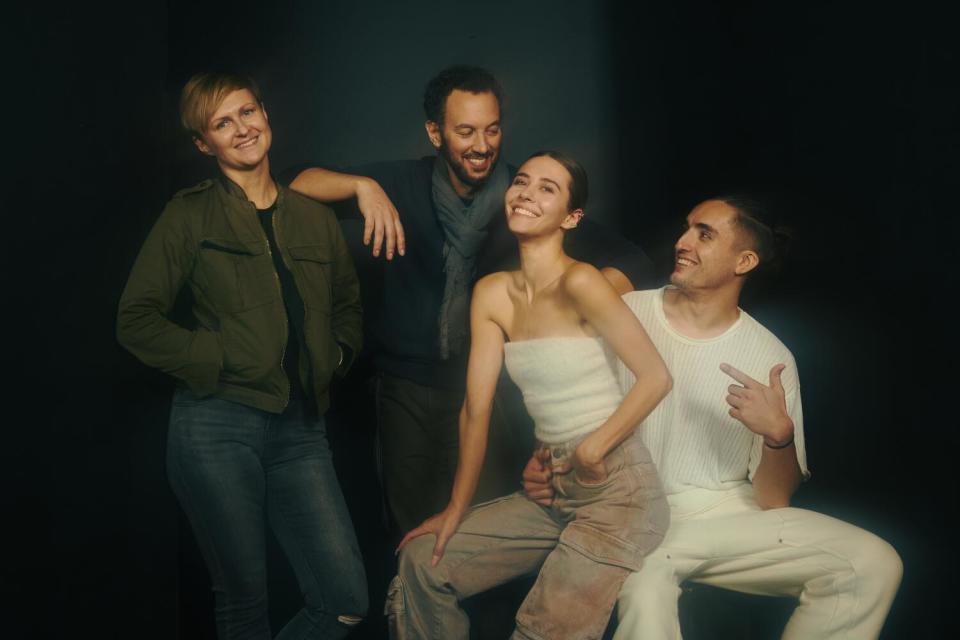 Four people pose for a portrait.