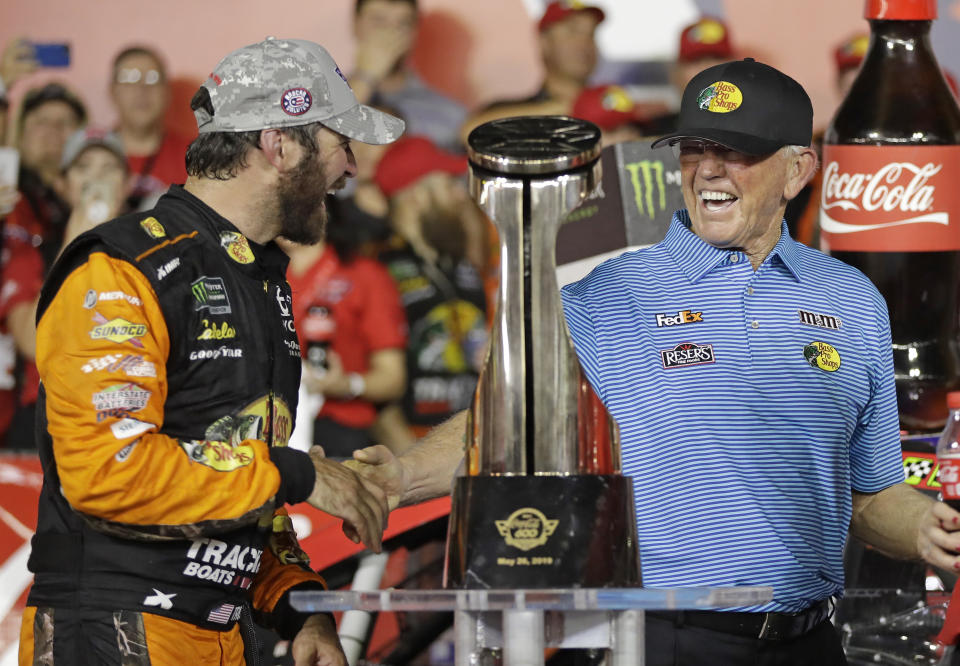 FILE - In this May 26, 2019, file photo, Martin Truex Jr., left, is congratulated by team owner Joe Gibbs in Victory Lane after winning the NASCAR Cup Series auto race at Charlotte Motor Speedway in Concord, N.C. NASCAR's season officially opens Sunday, Feb. 16, 2020, with the Daytona 500 at Daytona International Speedway. (AP Photo/Chuck Burton)