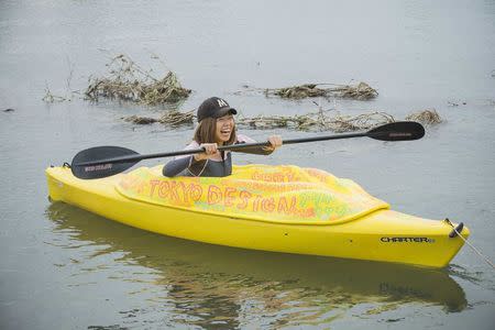 Japanese artist Megumi Igarashi, known as Rokudenashiko, paddles in her kayak modeled on her vagina in the Tama river in Tokyo in this October 19, 2013 picture provided by Eigo Shimojo. Igarashi, who made figures of Lady Gaga and the kayak, said on July 16, 2014 from jail she was "outraged" by her arrest and vowed a court fight against obscenity charges. Igarashi, 42, says she was challenging a culture of "discrimination" against discussion of the vagina in Japanese society. Picture taken October 19, 2013. REUTERS/Eigo Shimojo/Handout via Reuters