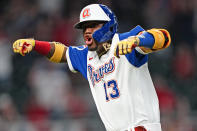 Atlanta Braves Ronald Acuna Jr. (13) reacts after hitting a home run in the seventh inning of a baseball game against the Philadelphia Phillies Sunday, April 11, 2021, in Atlanta. (AP Photo/John Bazemore)