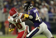 Kansas City Chiefs wide receiver Tyreek Hill, left, rushes against Baltimore Ravens cornerback Marlon Humphrey in the second half of an NFL football game, Sunday, Sept. 19, 2021, in Baltimore. (AP Photo/Julio Cortez)