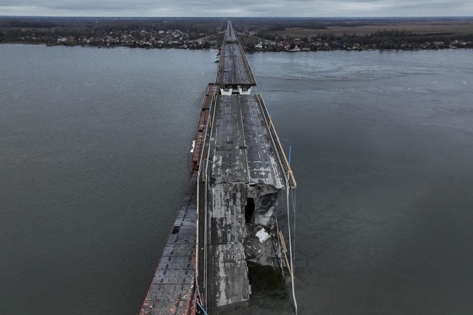 General view of the damaged Antonivsky Bridge in Kherson, Ukraine, Sunday, Nov. 27, 2022. The bridge, the main crossing point over the Dnipro river in Kherson, was destroyed by Russian troops in earlier November, after Kremlin's forces withdrew from the southern city. (AP Photo/Bernat Armangue)