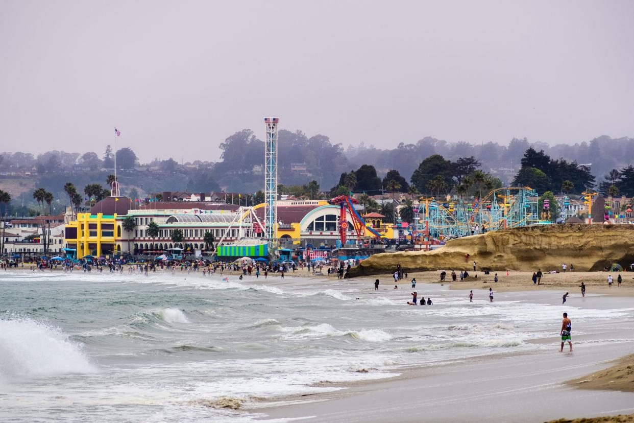 July 1, 2018 Santa Cruz / CA / USA - The Crowds having fun on the beach and at the Santa Cruz boardwalk on a foggy day;