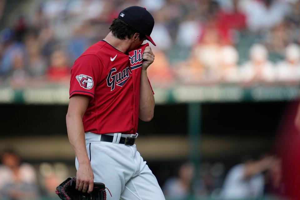 Cleveland Guardians' Cal Quantrill wipes his face as he walks off the field in the first inning of the team's baseball game against the Atlanta Braves, Wednesday, July 5, 2023, in Cleveland. (AP Photo/Sue Ogrocki)
