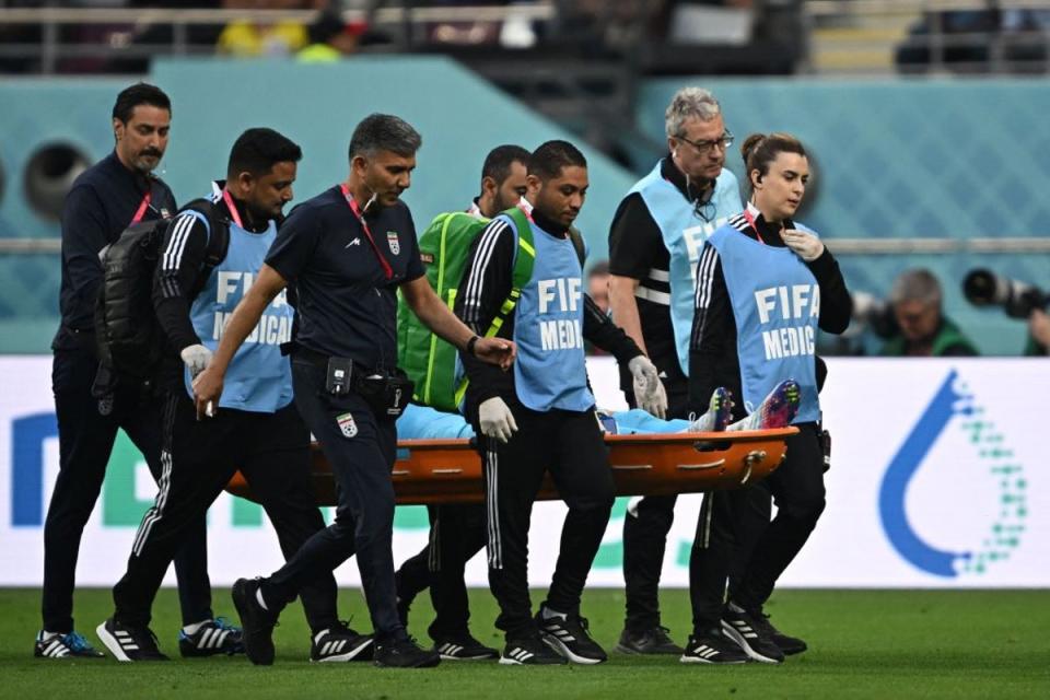 Alireza Beiranvand leaves the pitch on a stretcher (AFP via Getty Images)