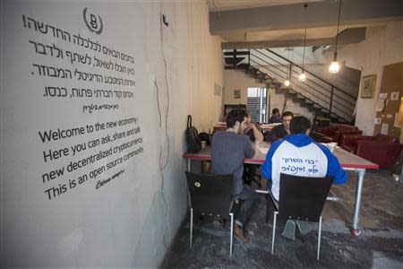 People sit inside the Bitcoin Embassy in Tel Aviv February 2, 2014. REUTERS/Baz Ratner