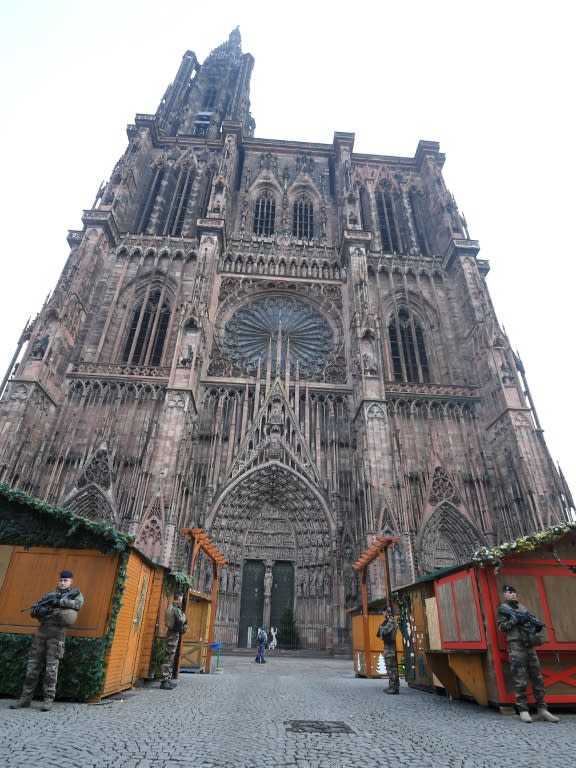 French soldiers stand guard at the closed Christmas market in Strasbourg cathedral after the shooting