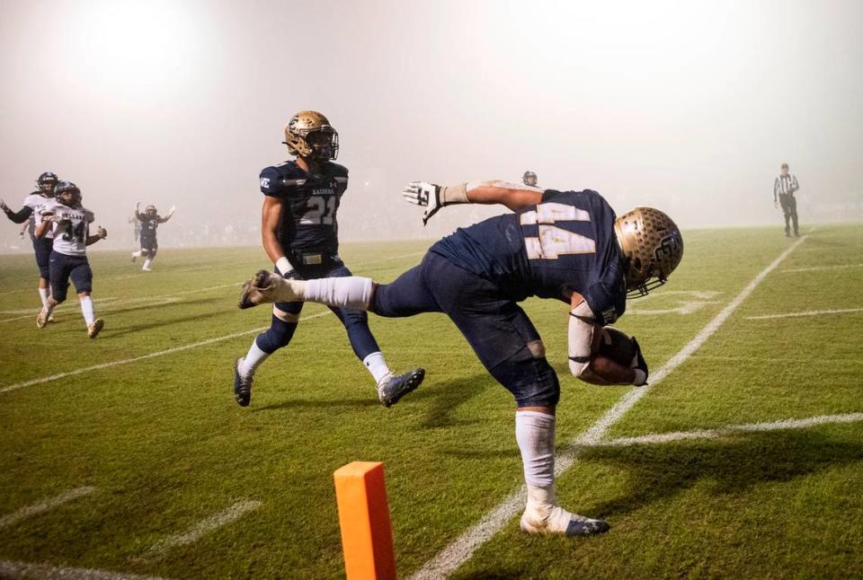 Central Catholic’s Aiden Taylor runs for a touchdown in the second half of the CIF Division II Northern California Regional Championship game with Bullard (Fresno) at Central Catholic High School in Modesto, Calif., Dec. 3, 2021. Central Catholic won the game 44-41.