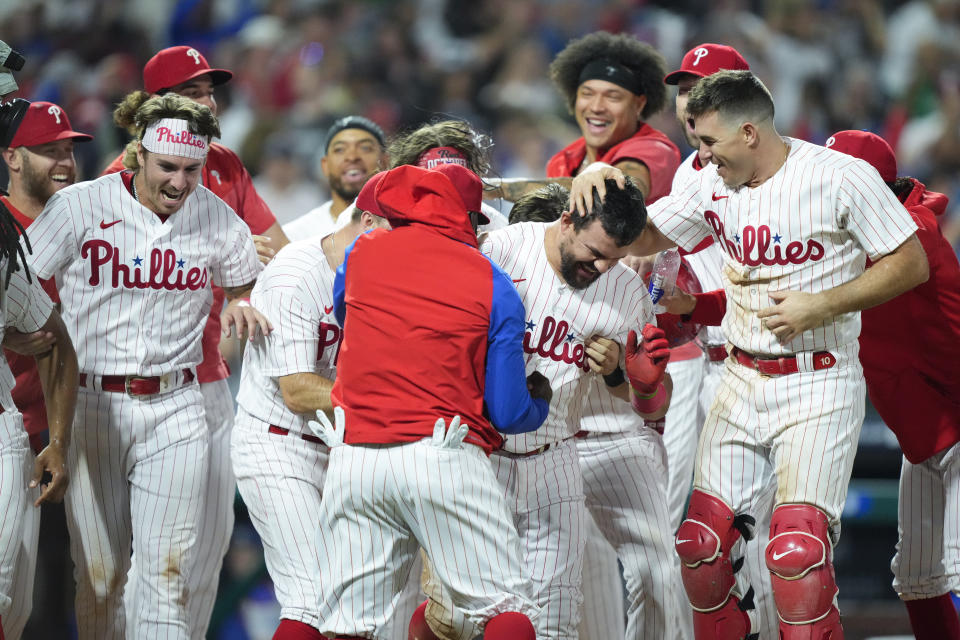 Philadelphia Phillies' Kyle Schwarber, center right, celebrates with teammates after hitting a home run off Los Angeles Dodgers' Caleb Ferguson during the ninth inning of a baseball game, Friday, June 9, 2023, in Philadelphia. (AP Photo/Matt Rourke)