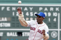 Meb Keflezighi throws the ceremonial first pitch before a baseball game between the Boston Red Sox and the Los Angeles Angels, Sunday, April 14, 2024, in Boston. (AP Photo/Michael Dwyer)