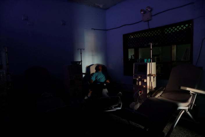 William Lopez, 45, a patient with kidney disease, waits for the electricity to return at a dialysis center during a blackout in Maracaibo, Venezuela. (Photo: Ueslei Marcelino/Reuters)