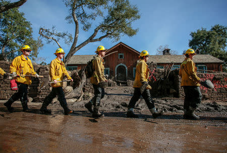 Rescue workers enter properties to look for missing persons after a mudslide in Montecito, California, U.S. January 12, 2018. REUTERS/ Kyle Grillot