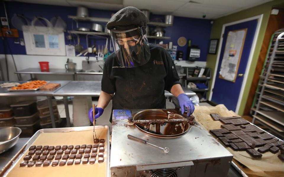 Owner Jennifer Posey creates a batch of pomegranate Champagne truffles at Hedonist Artisan Ice Cream & Chocolates on South Avenue in Rochester on Tuesday, Nov. 17, 2020.