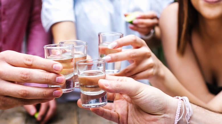women with clear alcohol shots
