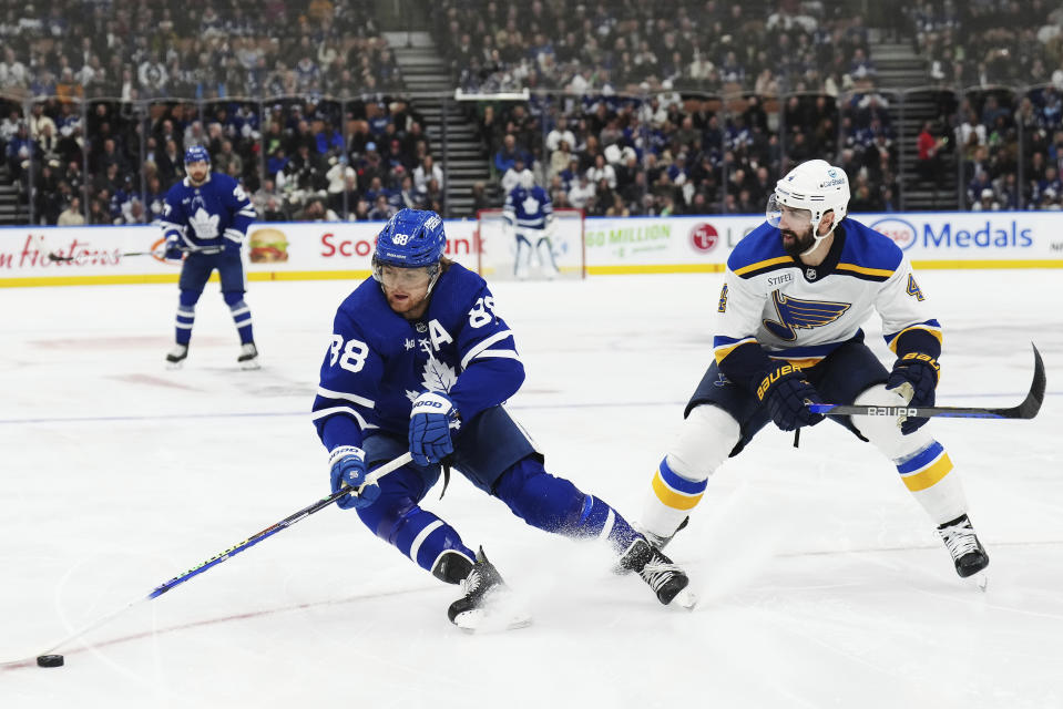 Toronto Maple Leafs forward William Nylander (88) protects the puck from St. Louis Blues defenseman Nick Leddy (4) during the second period of an NHL hockey game, Tuesday, Feb. 13, 2024 in Toronto. (Nathan Denette/The Canadian Press via AP)