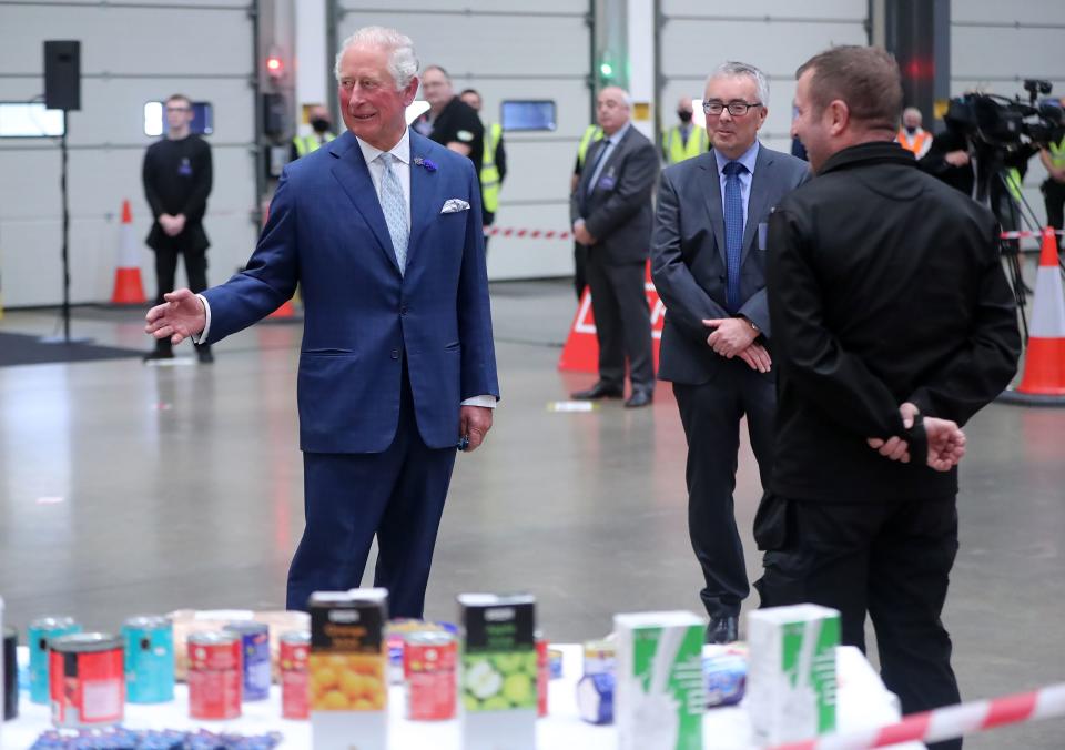 Britain's Prince Charles, Prince of Wales (L) shares a joke with driver Stephen Taggart (R) during a visit to Henderson Foodservice's food and grocery distribution centre in Newtownabbey, near Belfast, on September 30, 2020, where he thanked them for their efforts during the COVID-19 pandemic, and coping with the unprecedented demand they faced in recent months. (Photo by Niall Carson / POOL / AFP) (Photo by NIALL CARSON/POOL/AFP via Getty Images)