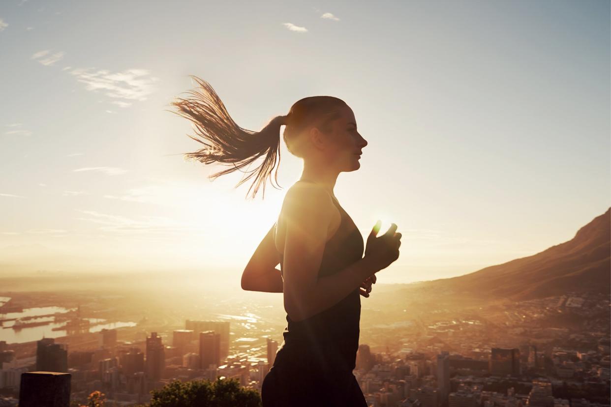 a woman running during sunset