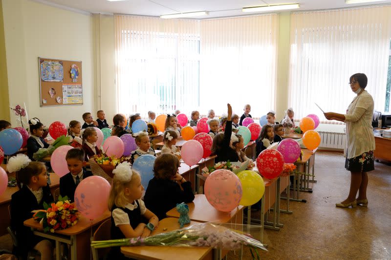 FILE PHOTO: A teacher and first graders are seen in the classroom on the first day of the new school year in Moscow