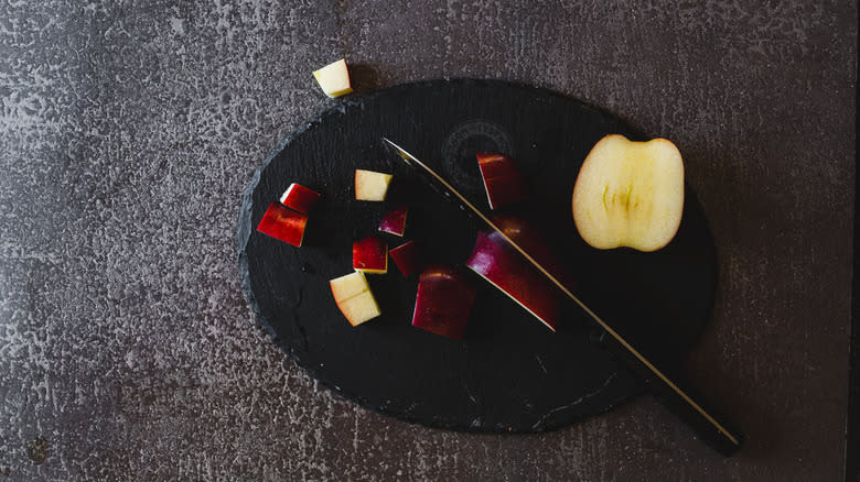 apple diced on black cutting board