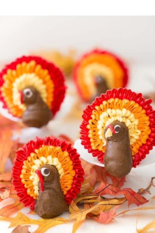 <p>Preppy Kitchen</p><p>The turkey bodies are piped with some chocolate buttercream and a large round tip and all those feathers were made with the flick of a wrist and small petal tips.</p><p><strong>Get the recipe: </strong><a href="https://preppykitchen.com/turkey-cupcakes/" rel="nofollow noopener" target="_blank" data-ylk="slk:Playful Turkey Cupcakes;elm:context_link;itc:0;sec:content-canvas" class="link "><strong>Playful Turkey Cupcakes</strong></a></p>