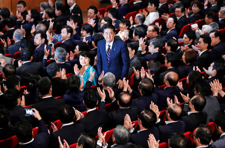 Japan's Prime Minister Shinzo Abe, who is also the ruling Liberal Democratic Party's (LDP) leader, stands up after winning the leadership vote at the party's headquarters in Tokyo, Japan September 20, 2018. REUTERS/Toru Hanai