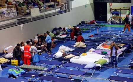 People are seen preparing to spend the night in a gym following an earthquake in Amatrice, central Italy, August 25, 2016. REUTERS/Ciro De Luca