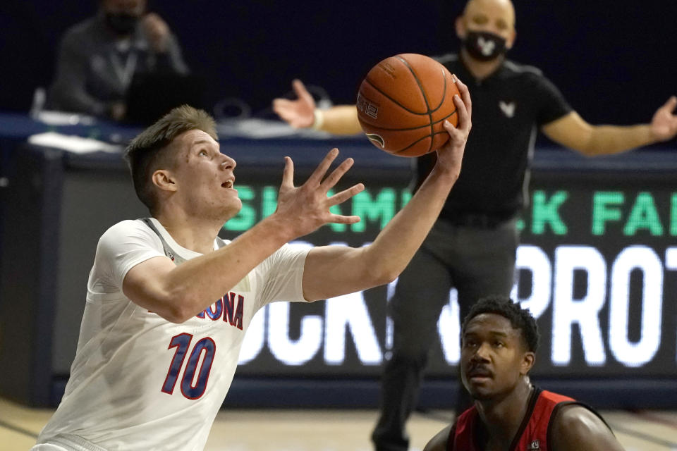 Arizona forward Azuolas Tubelis (10) shoots over Eastern Washington guard Kim Aiken Jr. during the first half of an NCAA college basketball game, Saturday, Dec. 5, 2020, in Tucson, Ariz. (AP Photo/Rick Scuteri)