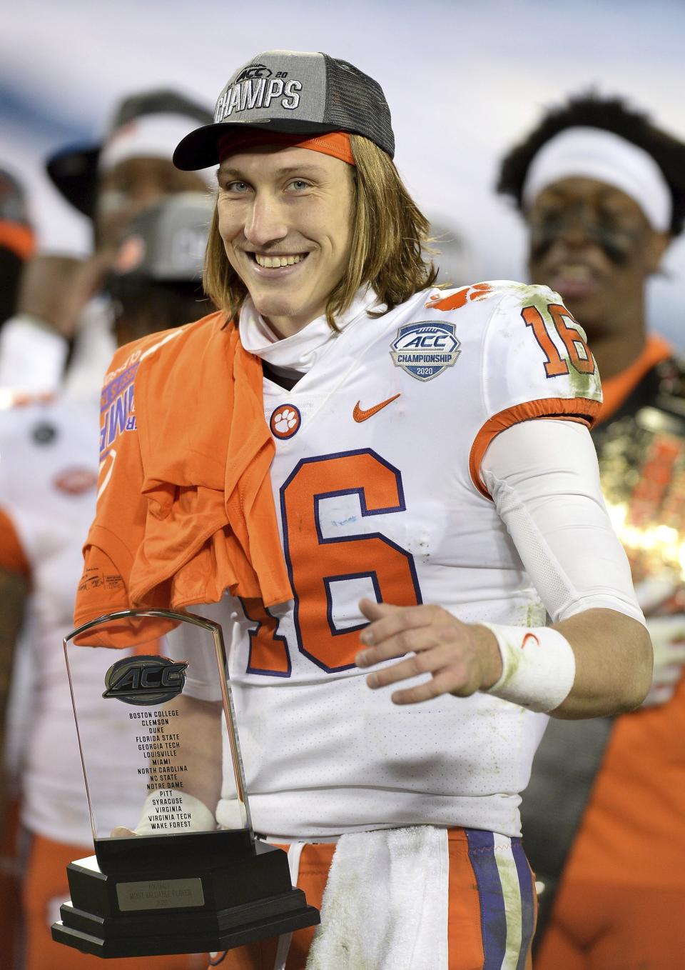 Clemson quarterback Trevor Lawrence holds the MVP Trophy after defeating Notre Dame in the Atlantic Coast Conference championship NCAA college football game, Saturday, Dec. 19, 2020, in Charlotte, N.C. (Jeff Siner/The News & Observer via AP)