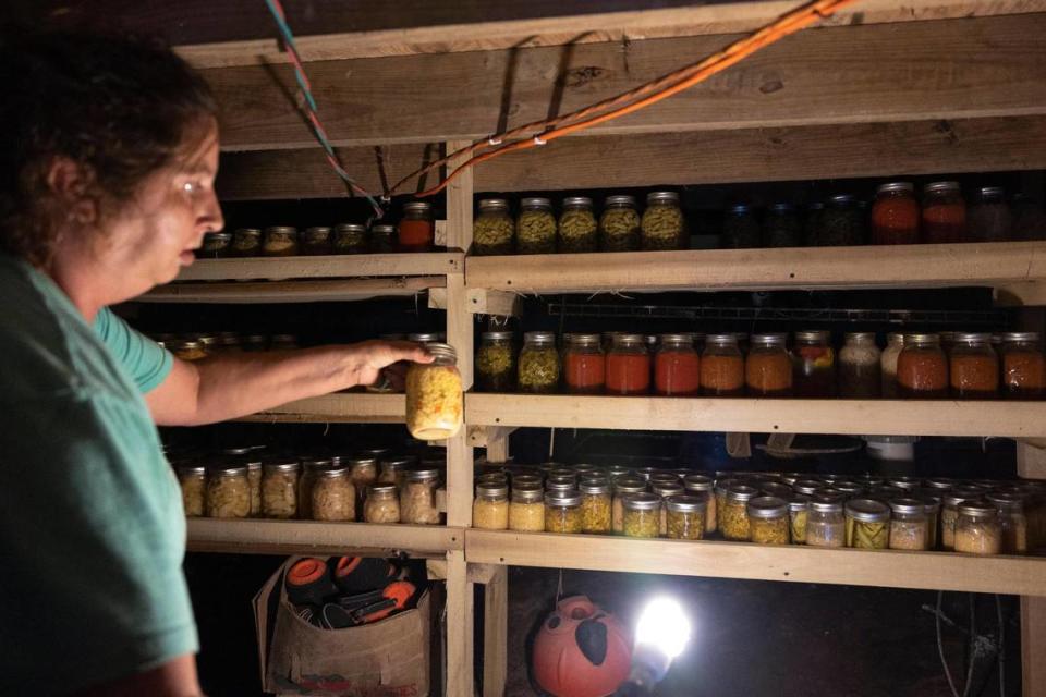 Maurica Cornett shows her canned produce, with vegetables grown from her garden, in her basement at their home in Letcher County, Ky, Tuesday, August 8, 2023.