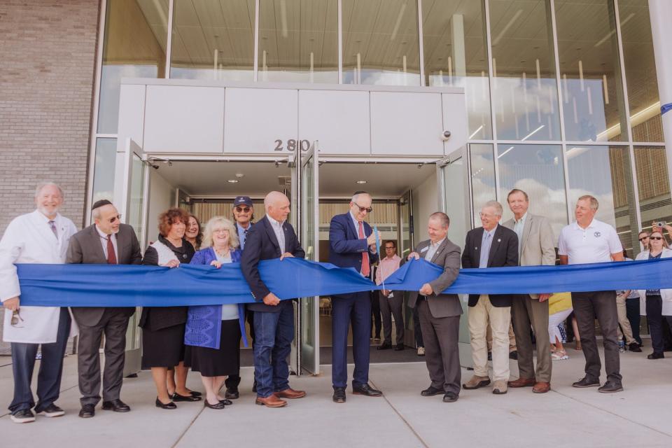 Touro College President Alan Kadish cuts the ribbon at a grand opening ceremony for the new College of Osteopathic Medicine in Great Falls Monday.