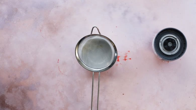 Small strainer over small bowl