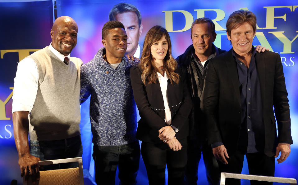 Actors Terry Crews, from left, Chadwick Boseman, Jennifer Garner, Kevin Costner and Denis Leary pose for a photograph at a news conference for the movie "Draft Day" in New York on Friday, Jan. 31, 2014, two days before the NFL football Super Bowl. (AP Photo/Paul Sancya)