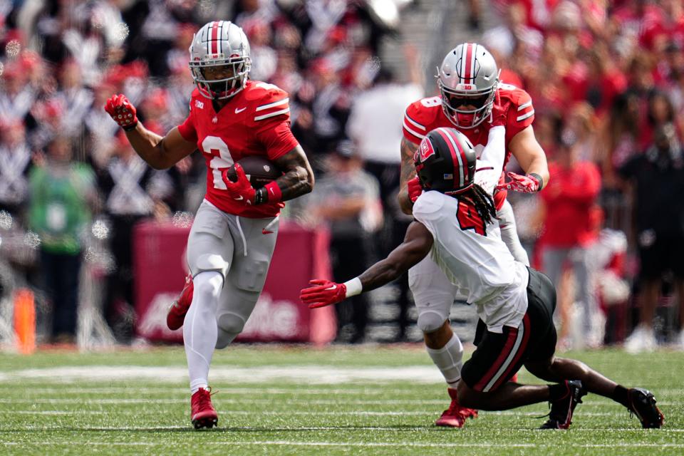Sep 16, 2023; Columbus, Ohio, USA; Ohio State Buckeyes wide receiver Emeka Egbuka (2) runs past Western Kentucky Hilltoppers defensive back Anthony Johnson Jr. (4) being blocked by tight end Cade Stover (8) during the NCAA football game at Ohio Stadium. Ohio State won 63-10.