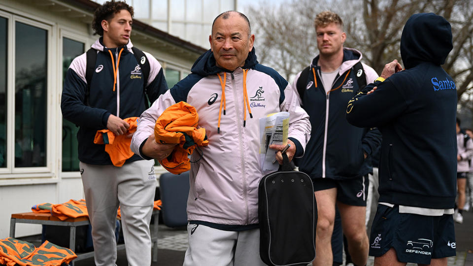 Eddie Jones is pictured walking ahead of Wallabies players before a game.